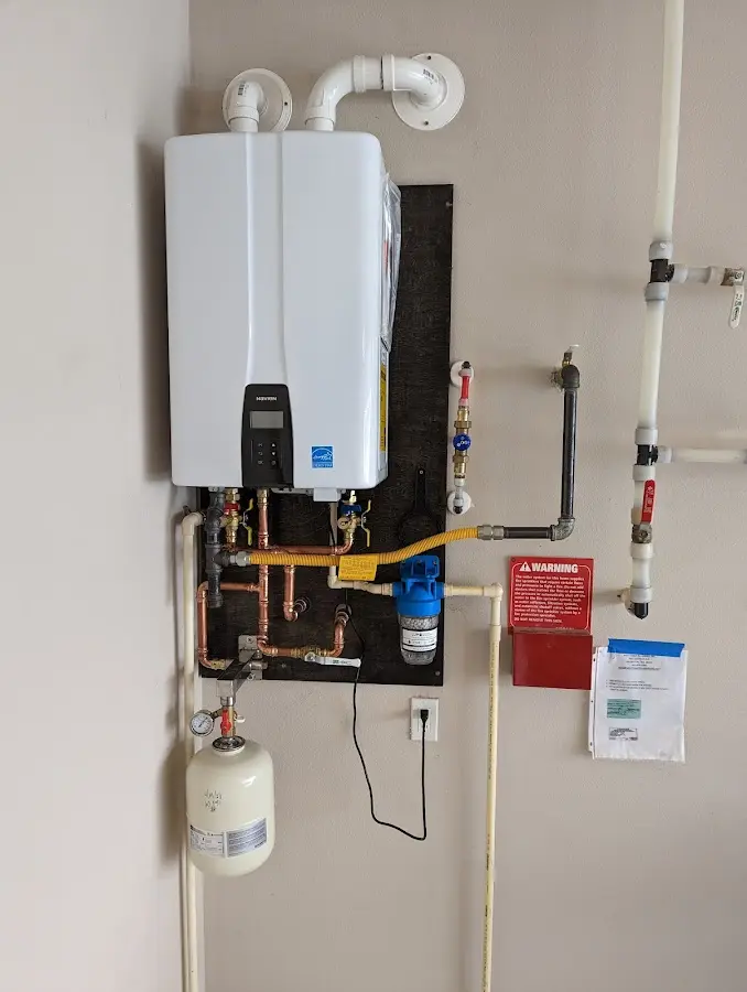 Professional plumber installing copper piping in a Saluda home